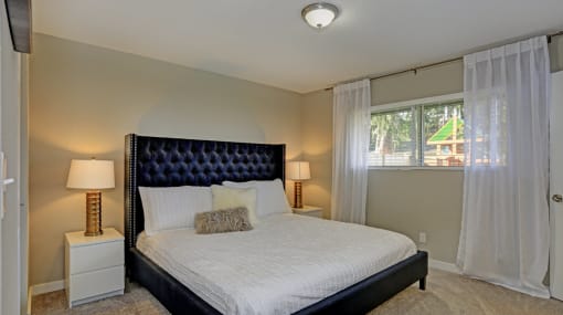 a bedroom with a bed and two night stands