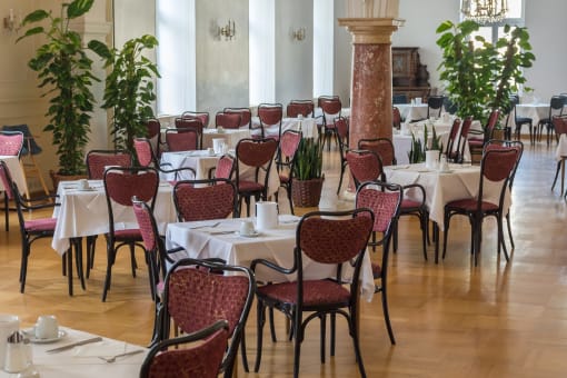 a large dining room with tables and chairs