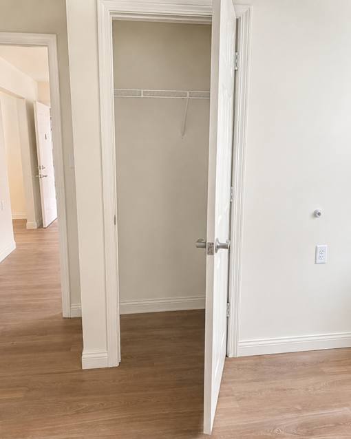 A white door with a hanger on it.