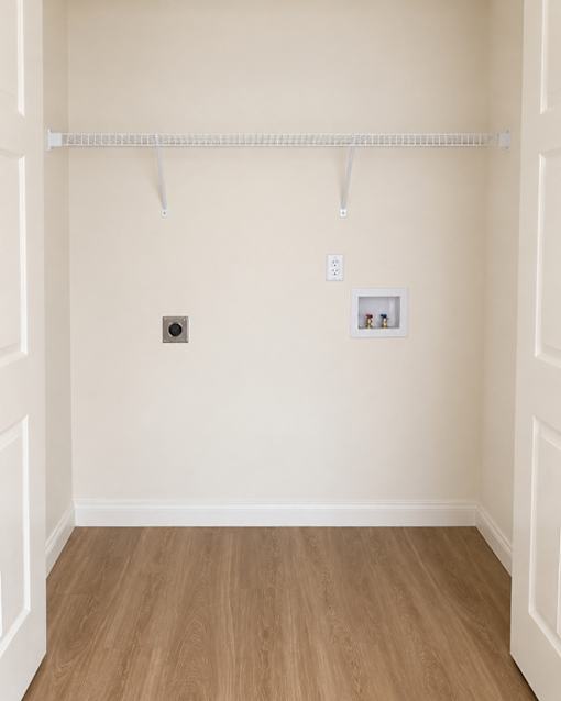 A white closet with a shelf and a picture on the wall.