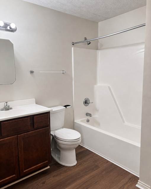 A white toilet sits next to a sink in a bathroom.