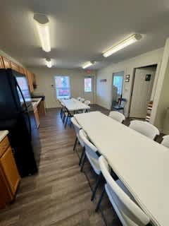 A room with a long table and chairs is shown.