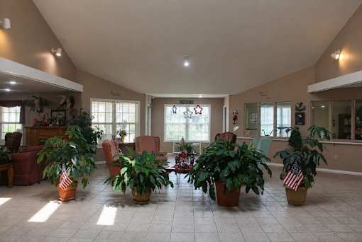 A living room with a large American flag plant pot in the middle.