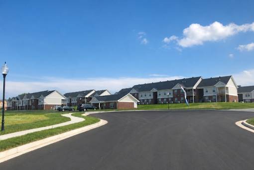 A row of houses with a street in front.