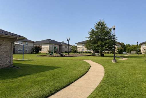 A residential area with houses, a sidewalk, and a street lamp.