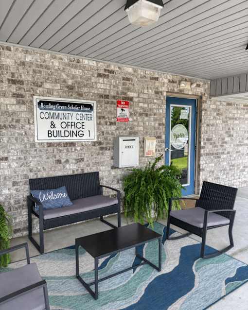 A sign on a brick wall reads "Bowling Green School House COMMUNITY CENTER & OFFICE BUILDING 1".