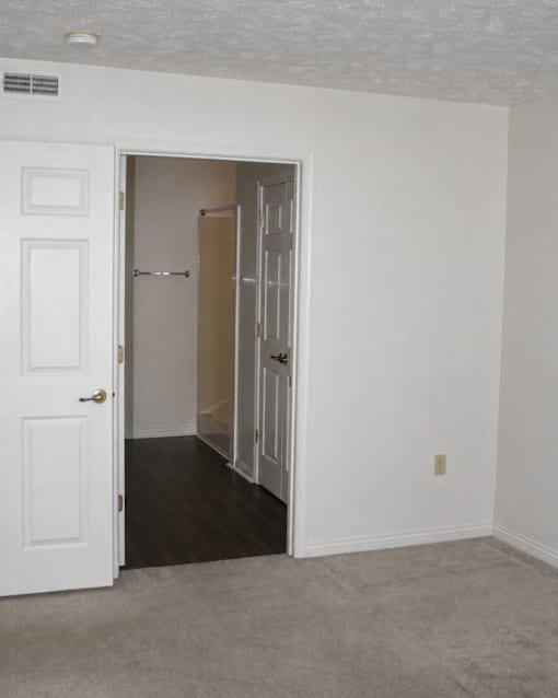 A white door is open to a hallway.
