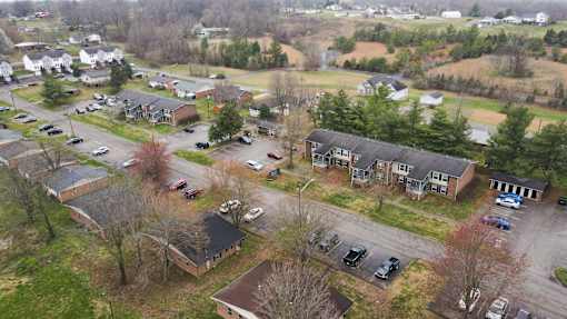 A bird's eye view of a residential area with houses and cars.