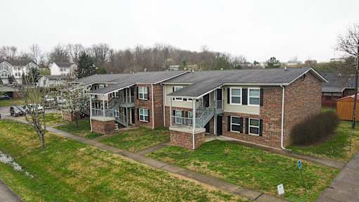 Apartment complex with a grassy front yard.