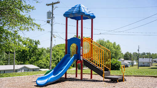 A blue and yellow slide in a playground.