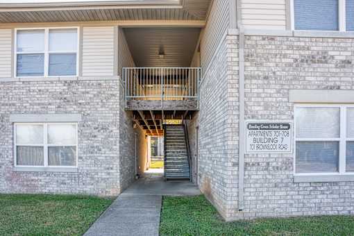 A brick building with a sign that says Apartments 701-708 10 to Monroe St.