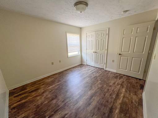 A room with wooden floors and white walls.