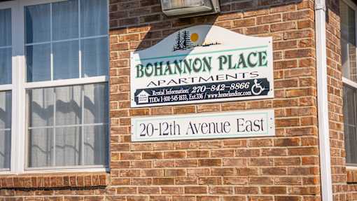 A sign on a brick building that says Bohannon Place Apartments.