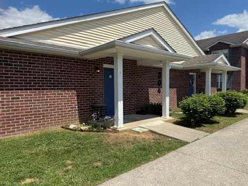 A house with a blue door and a white porch.