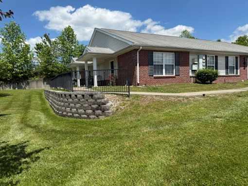 A house with a red brick exterior and a grey roof.