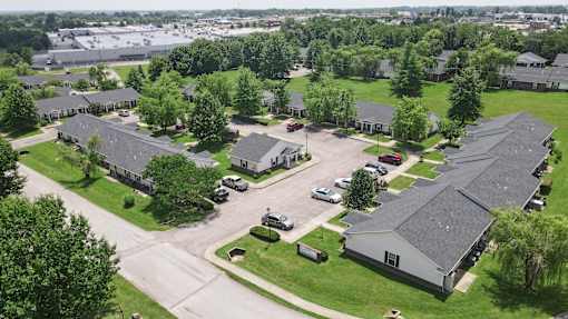 A large building complex with a parking lot in front.
