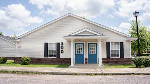 A white house with a blue door and windows.