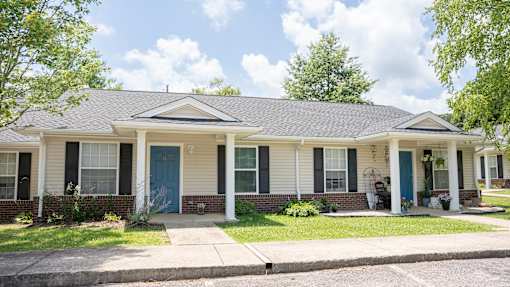 A house with a blue door and white siding.