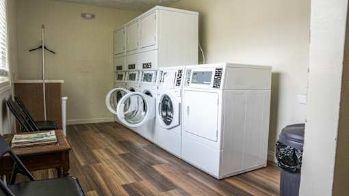 A washing machine and dryer stacked on top of each other in a laundry room.