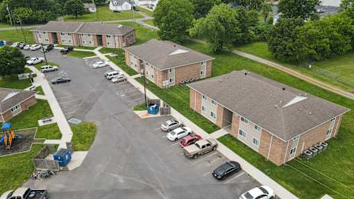 A parking lot in front of apartment buildings.
