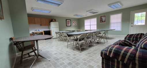 A dining room with a table and chairs.