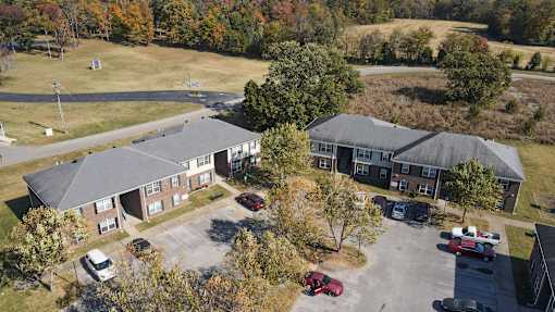 A large building with a parking lot in front of it.