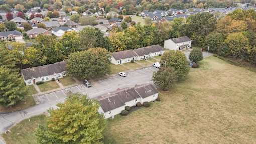 A bird's eye view of a residential area with houses and trees.