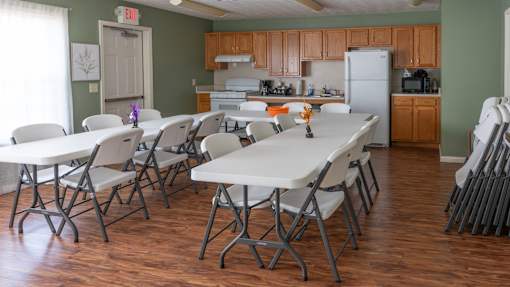 A dining room with a long table and chairs.