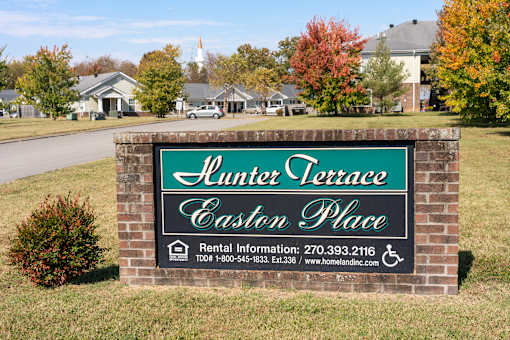 A sign for Hunting Terrace Eston Place with rental information.