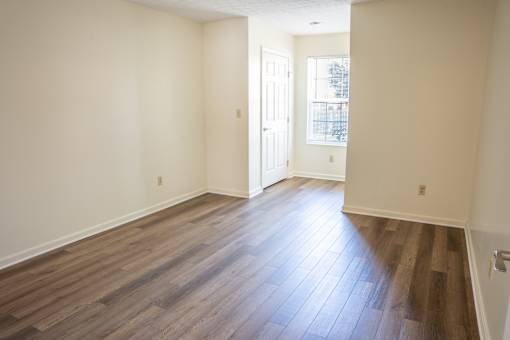 A room with wooden floors and white walls.