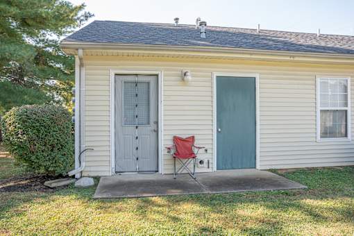 A small house with a red chair in front of it.