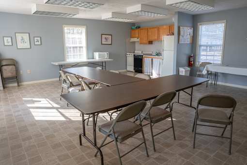 A kitchen with a table and chairs in the foreground.