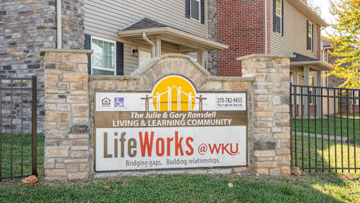 A sign for LifeWorks @ WKU is displayed in front of a building.
