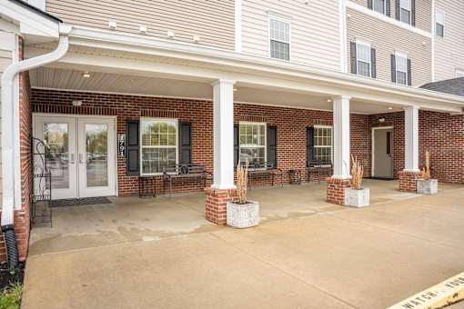 A building with a covered walkway and pillars.