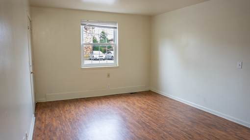 Empty room with a window showing a street view.