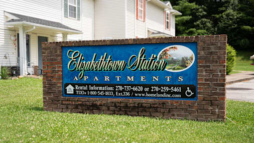 A sign for Elizabethown Station Apartments with rental information.