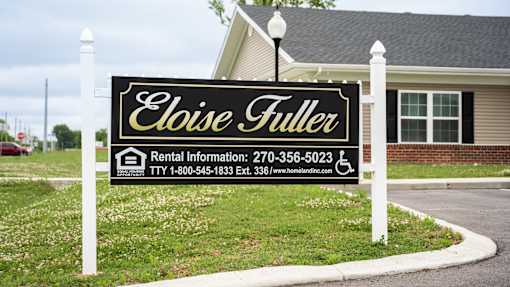 A sign for Eloise Fuller rental information is displayed in front of a house.