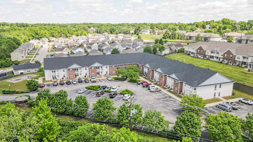 A large building with a parking lot in front of it.