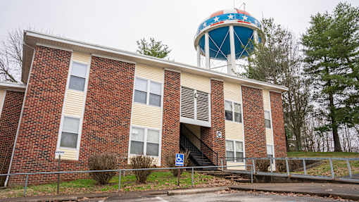 A red brick building with a water tower on top.