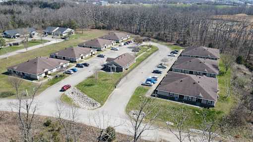 A bird's eye view of a residential area with houses and cars.