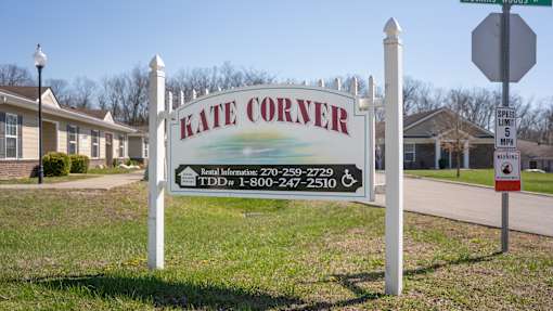 A sign for Kate Corner with a speed limit of 25 mph.