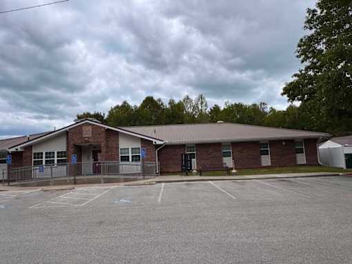 A building with a parking lot in front of it.