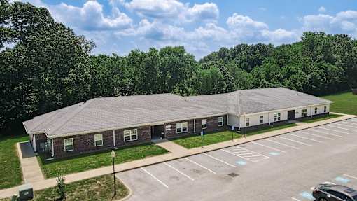 A large building with a parking lot in front of it.