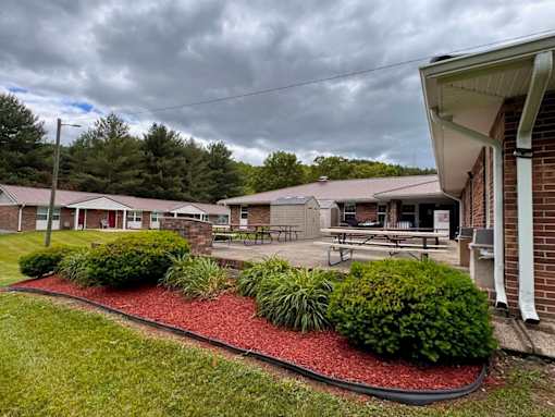 A building with a red mulch bed in front of it.