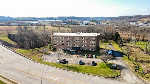 A large building with a parking lot in front of it.