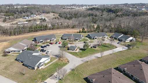 A bird's eye view of a residential area with houses and cars.