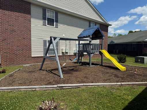 A playground with a blue roof and a yellow slide.