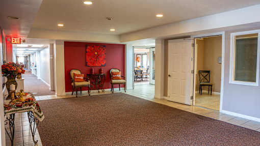 A room with a red wall and a white door.