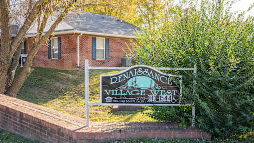 A sign for Penrose Village West with a phone number on it.