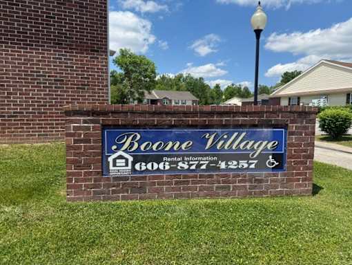 A sign for Boone Village with a phone number on it.